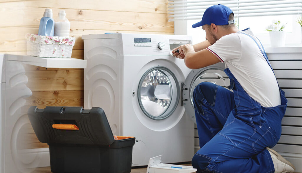 A Washing Machine Technician is repairing the Washing Machine